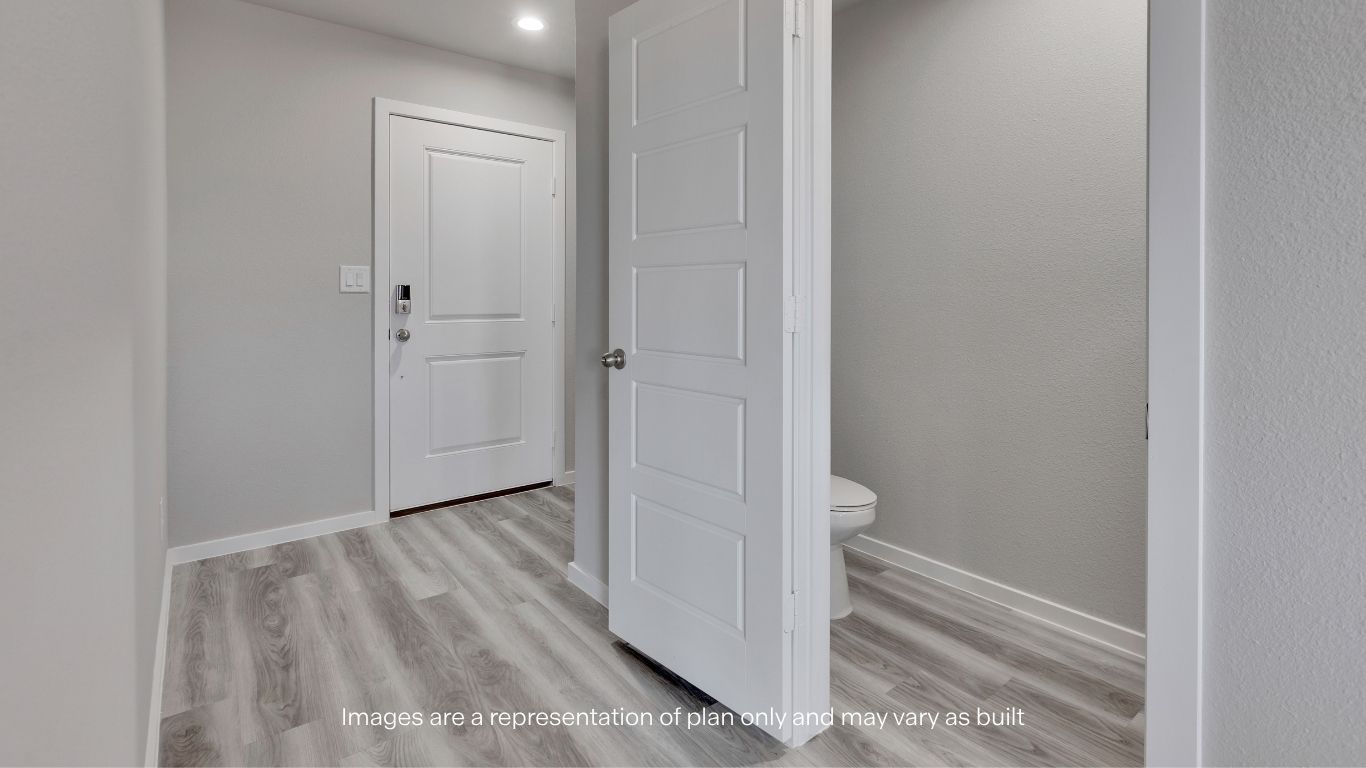 Step inside to a welcoming foyer featuring durable flooring and convenient access to the downstairs powder bathroom.