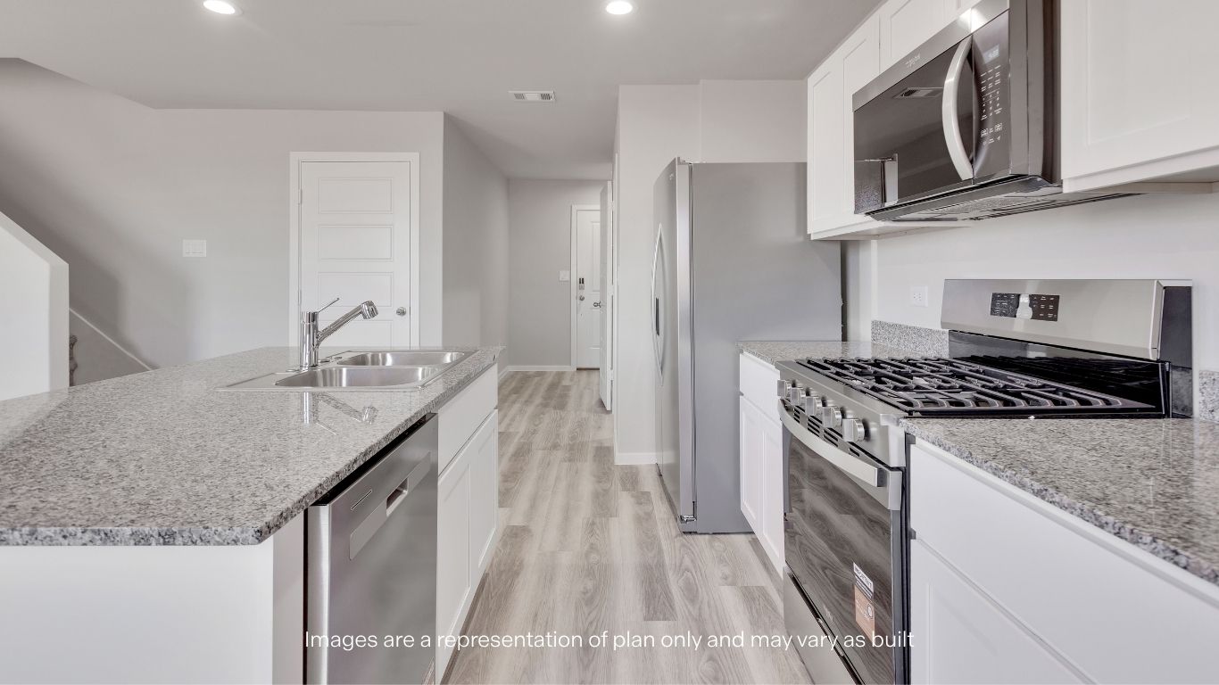 Enjoy modern finishes throughout the kitchen, including granite countertops, stainless steel appliances, and ample cabinet storage.