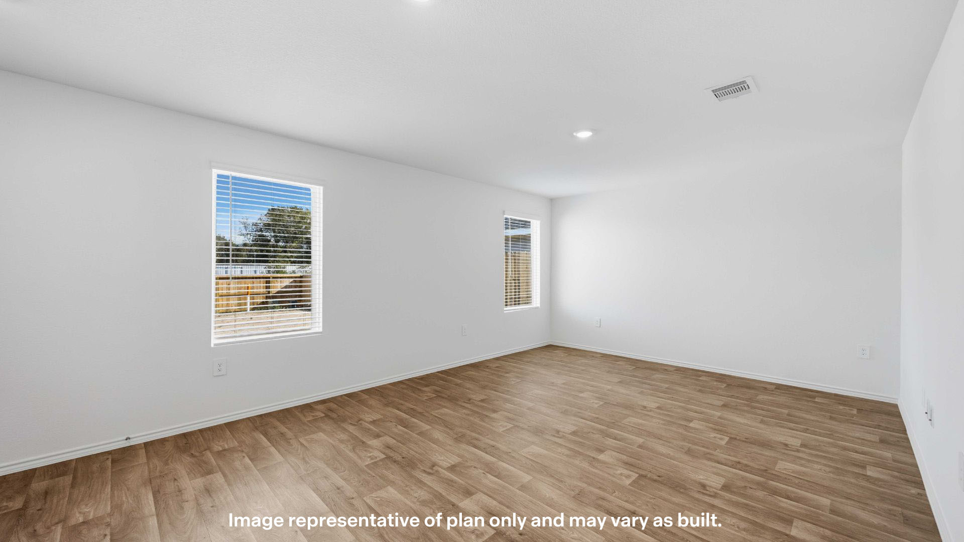 Spacious living and family room space with light allowing windows