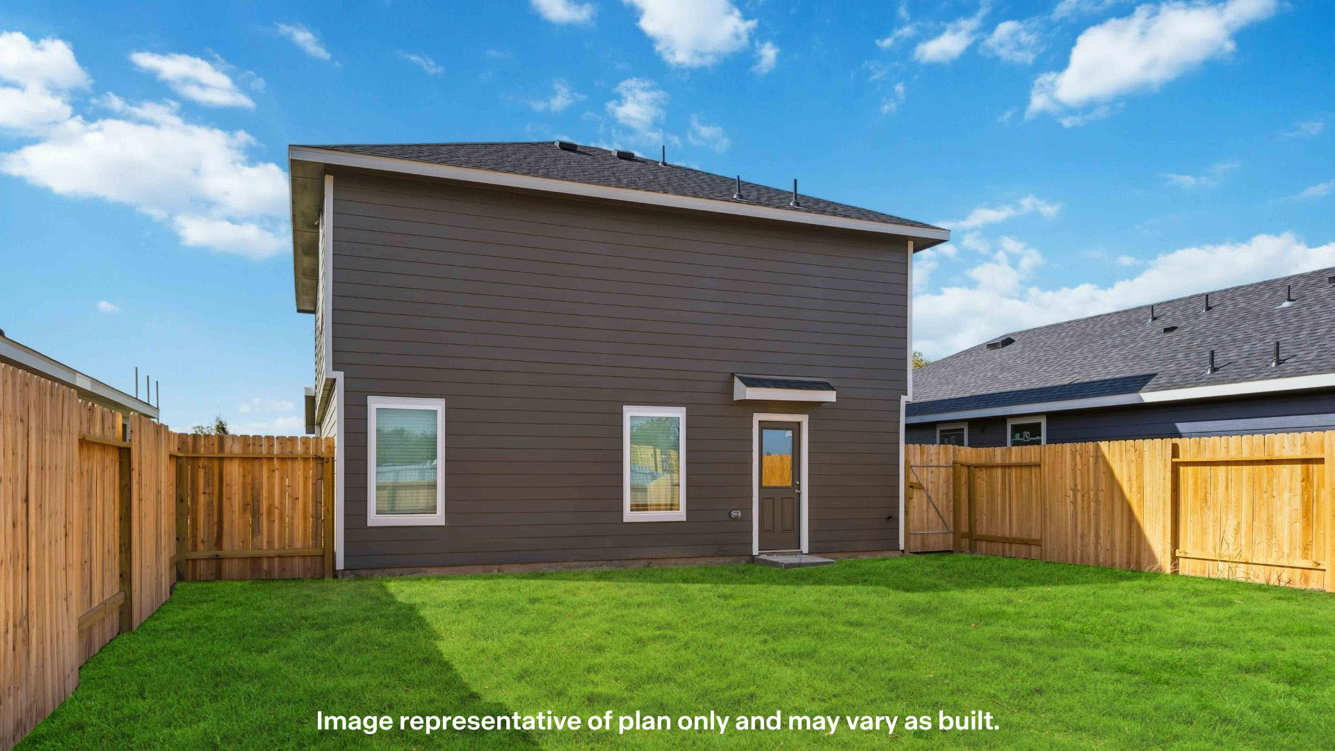 Covered back patio area overlooking private fenced-in backyard