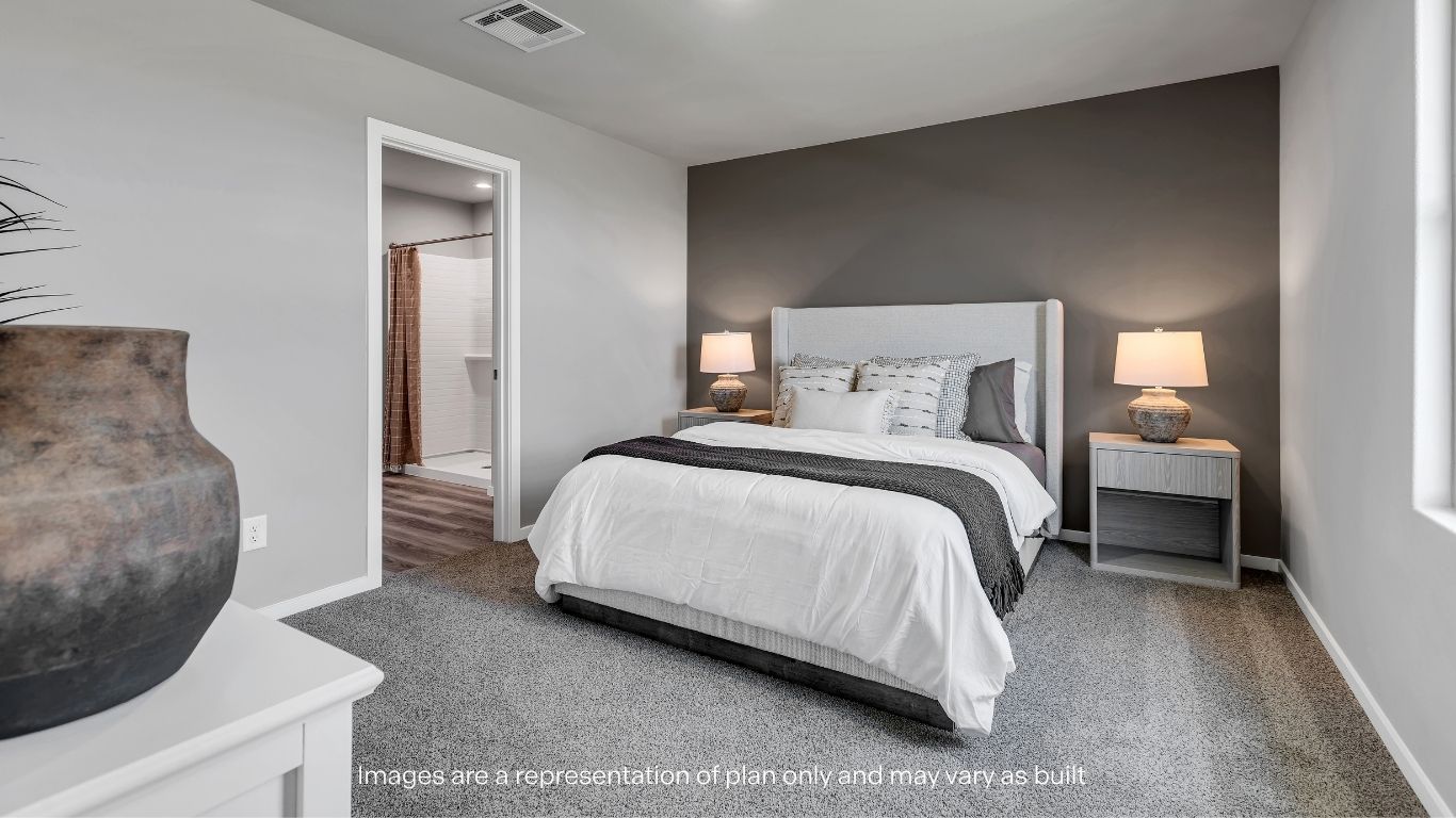 Primary bedroom with plush carpet floors and light allowing double windows