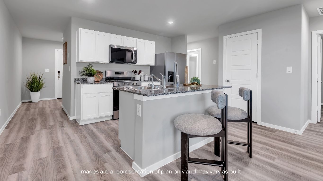 Open concept kitchen with stainless steel appliances, shaker style cabinets, and elevated finishes