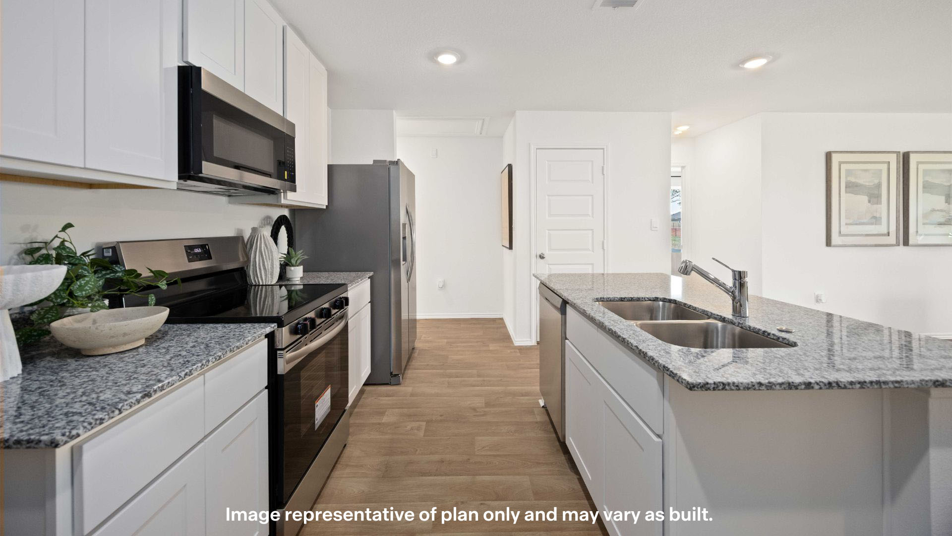 Open concept kitchen with stainless steel appliances, shaker style cabinets, and elevated finishes