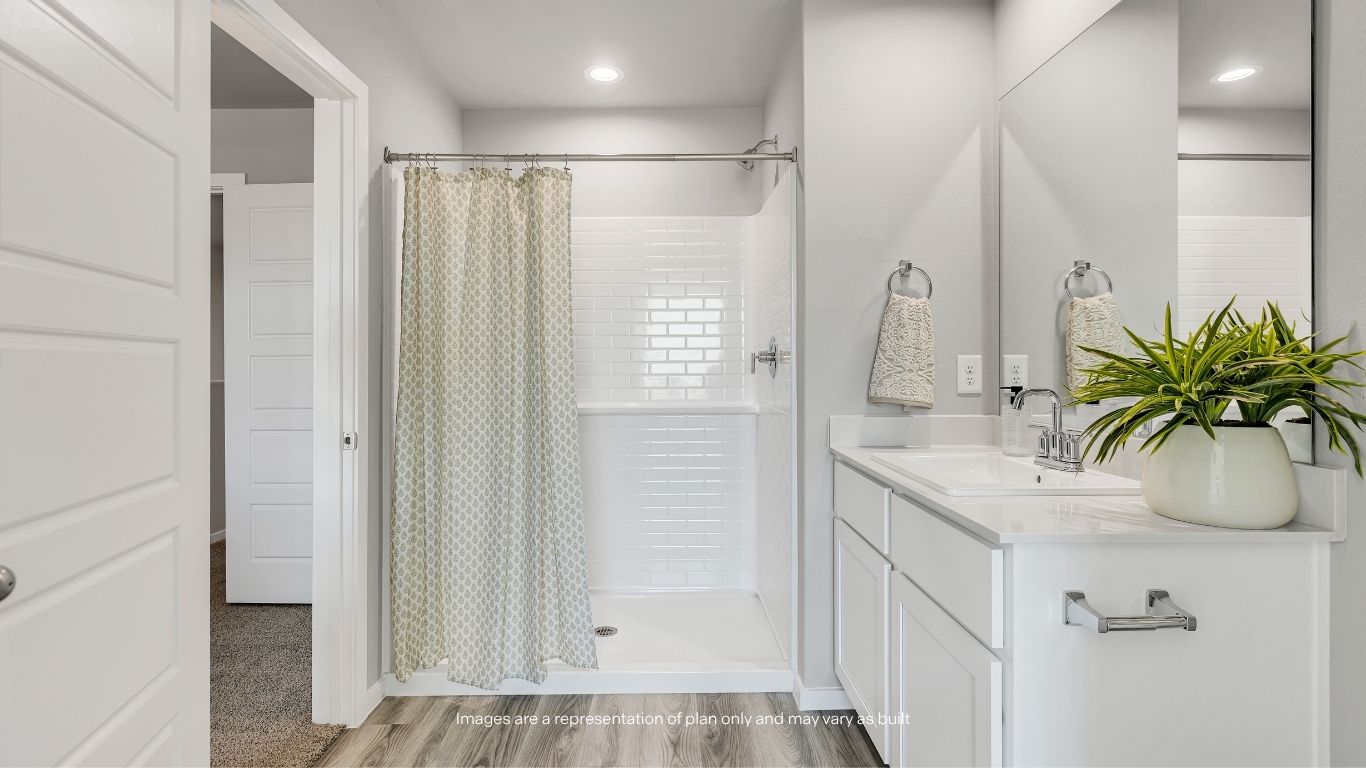 Enjoy a bright and functional en suite bathroom featuring modern finishes and a convenient shower-tub combination.