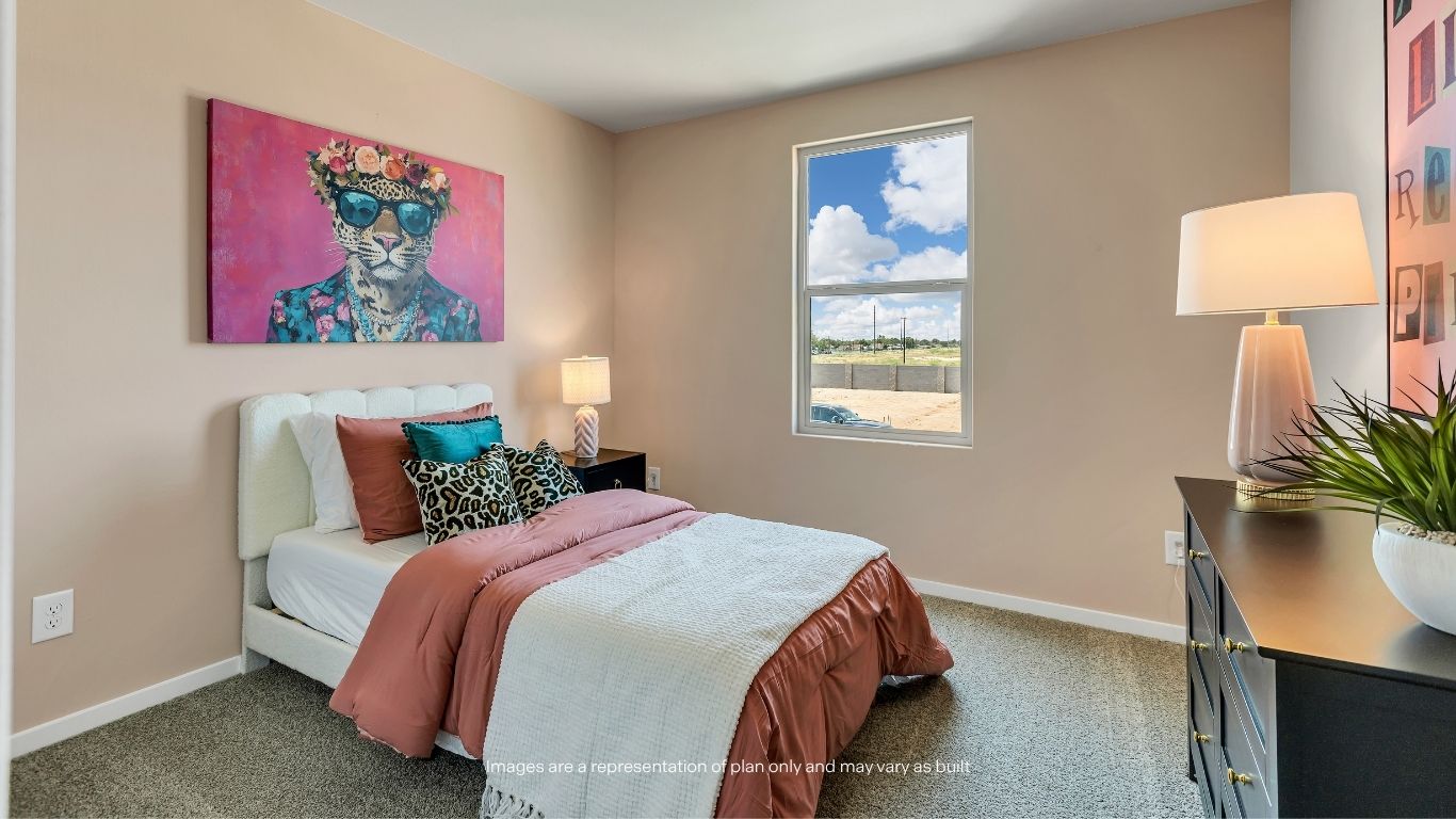 A generously sized secondary bedroom with soft carpeting and natural light creates a comfortable space for family or guests.