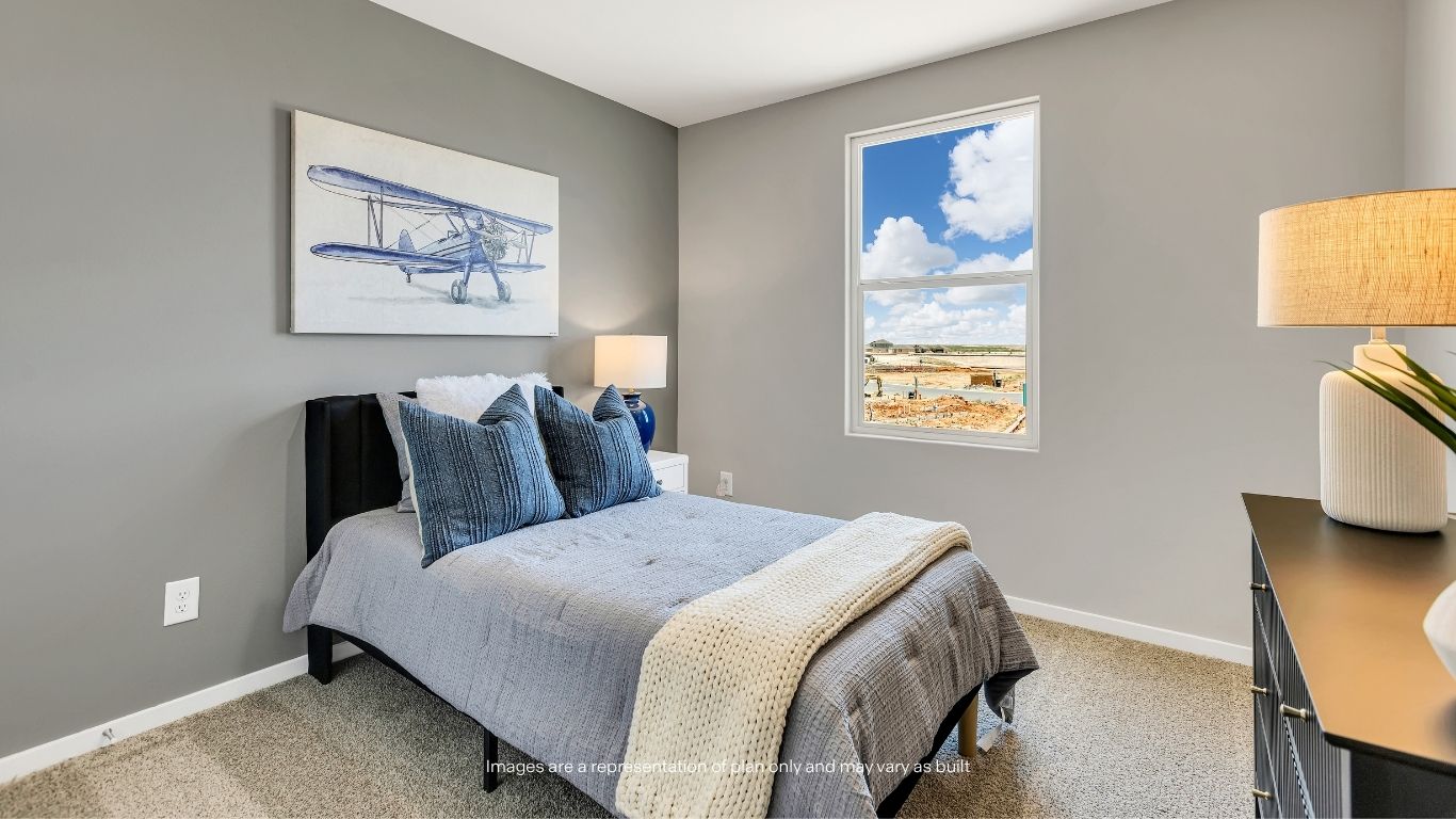 This spacious secondary bedroom offers plush carpeting, abundant natural light, and ample room for family members, guests, or a home office setup.