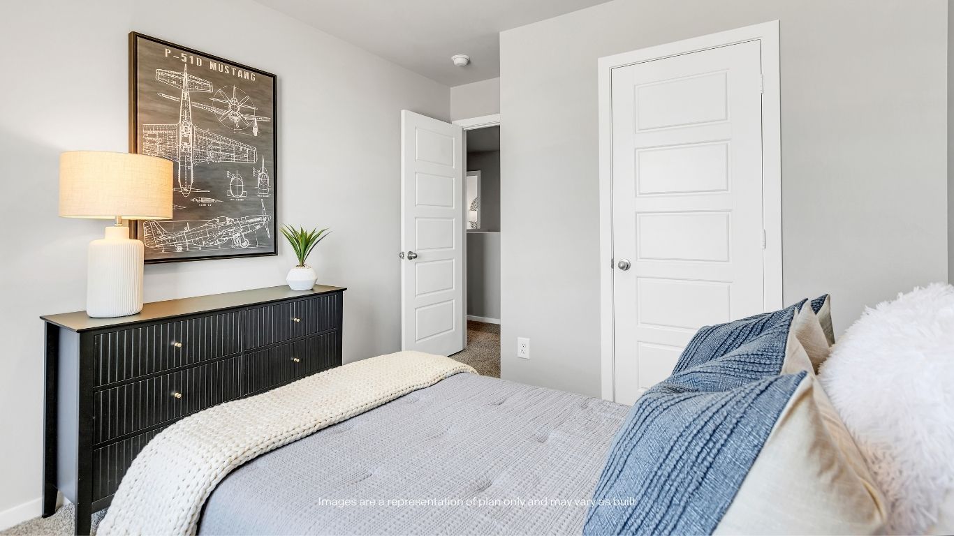 Designed with versatility in mind, this bright guest bedroom includes a generous closet and comfortable layout to fit a variety of needs.