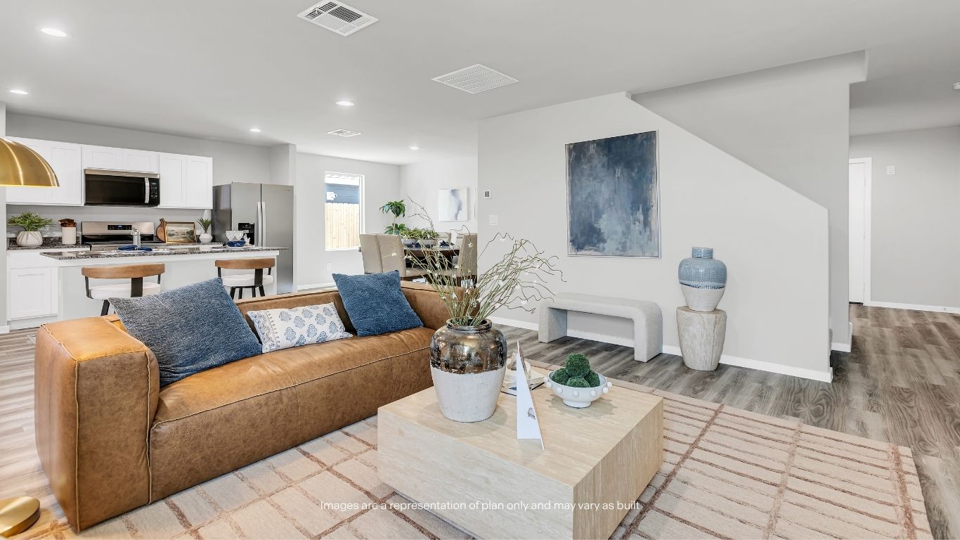 Designed for modern lifestyles, this open-concept layout keeps the living room, dining area, and kitchen connected throughout the home.