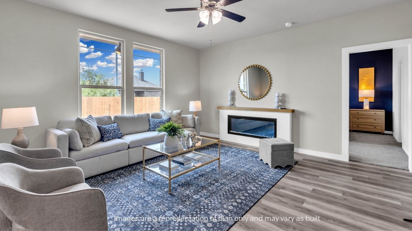 Spacious family room featuring large windows and a modern fireplace.
