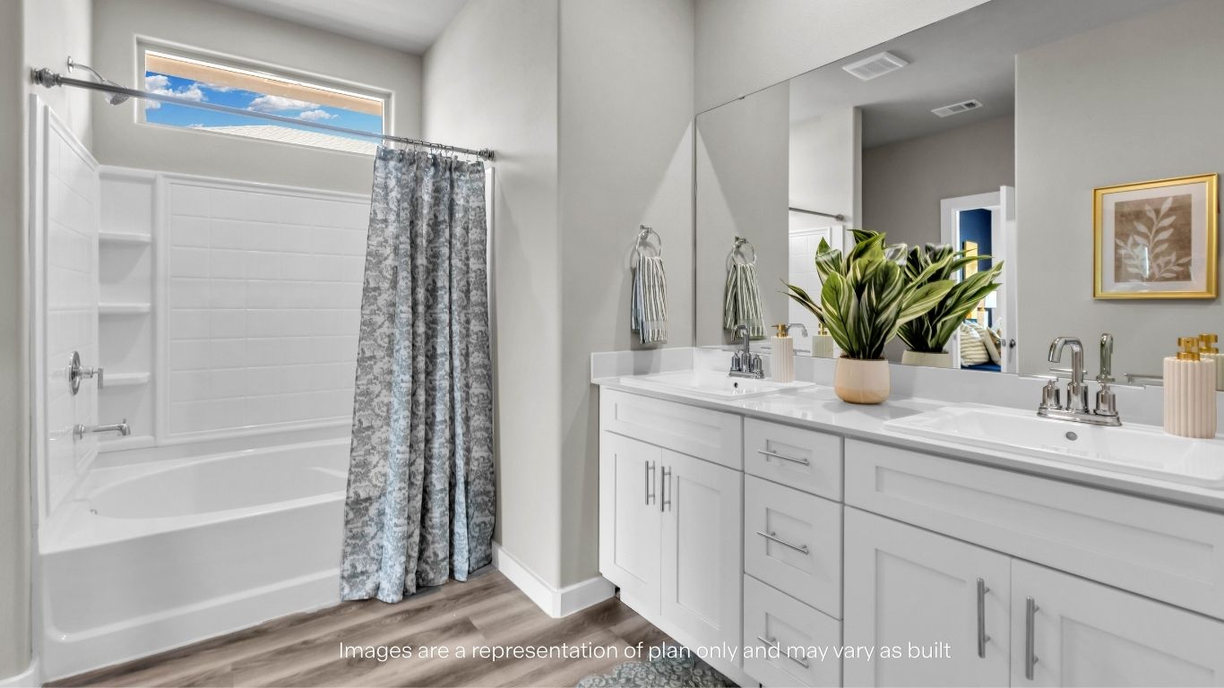 Spacious primary bathroom with dual sinks and modern cabinetry.