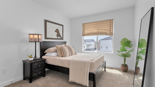 Upstairs bedroom with large window.