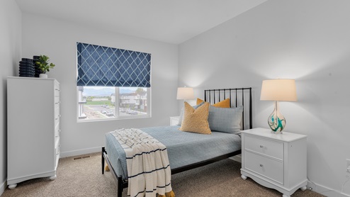 Upstairs bedroom with large window.