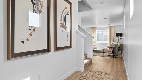 Entryway into the Millbrook floor plan has a staircase to the upstairs living space and around the corner to an open concept layout for the main floor.