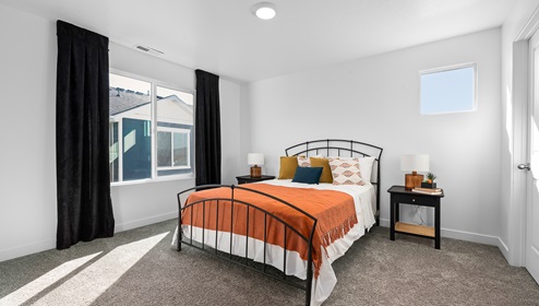 Large secondary bedroom with two windows.