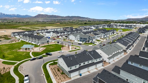 Aerial photo of the Northshore community in Saratoga Springs Utah with views of the modern townhomes for sale, nearby park and surrounding mountains.
