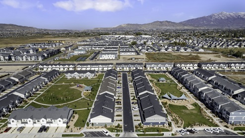 Aerial photo of the Northshore community with beautiful green park spaces between the rows of stylish townhomes in Saratoga Springs Utah.