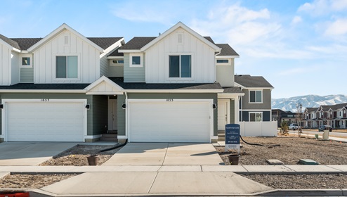 Exterior photo of a new townhome available in the Northshore community in Utah with it’s stylish multi colored exterior and covered porch.