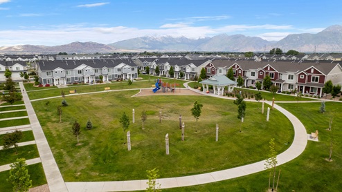 Beautiful aerial photo of the Northshore community by D.R. Horton of townhomes, community monument, clubhouse and pool and surrounding mountains and Utah Lake.