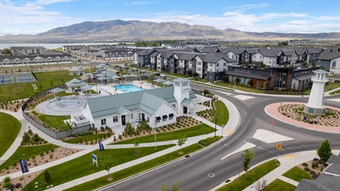 Beautiful aerial photo of the Northshore community by D.R. Horton of townhomes, community monument, clubhouse and pool and surrounding mountains and Utah Lake.