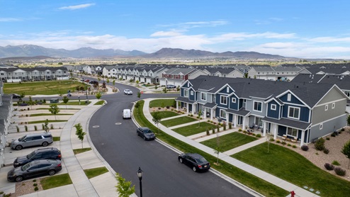 Beautiful aerial photo of the Northshore community by D.R. Horton of townhomes, community monument, clubhouse and pool and surrounding mountains and Utah Lake.