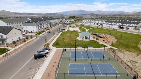Beautiful aerial photo of the Northshore community by D.R. Horton of townhomes, community monument, clubhouse and pool and surrounding mountains and Utah Lake.