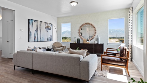 An open concept main area with 3 large windows letting in a lot of light and brightness in a Clover floor plan.