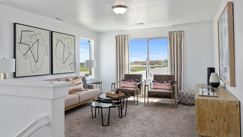The loft area upstairs in the Clover floor plan has 3 large windows letting in amazing light and airiness to the space.