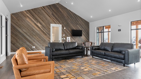 Large room with couches for entertaining at the Little Valley Gateway community clubhouse in Magna Utah.