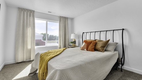 Large bedroom with window and square window.
