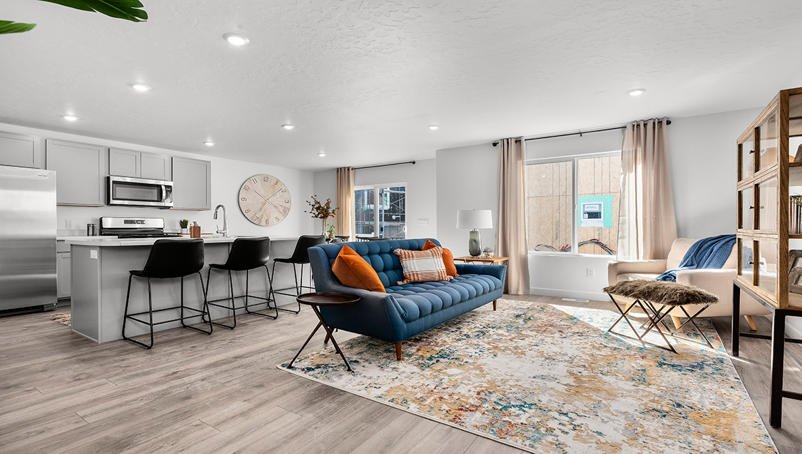 The living room on the main floor boast a large window and plenty of room for lounging or entertaining.