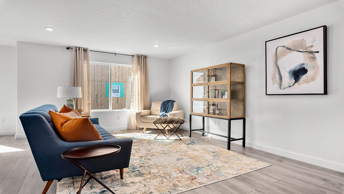 The living room on the main floor boast a large window and plenty of room for lounging or entertaining.