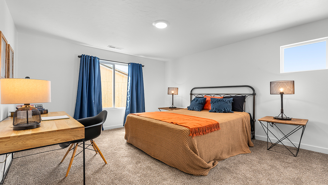 Large secondary bedroom with two windows.