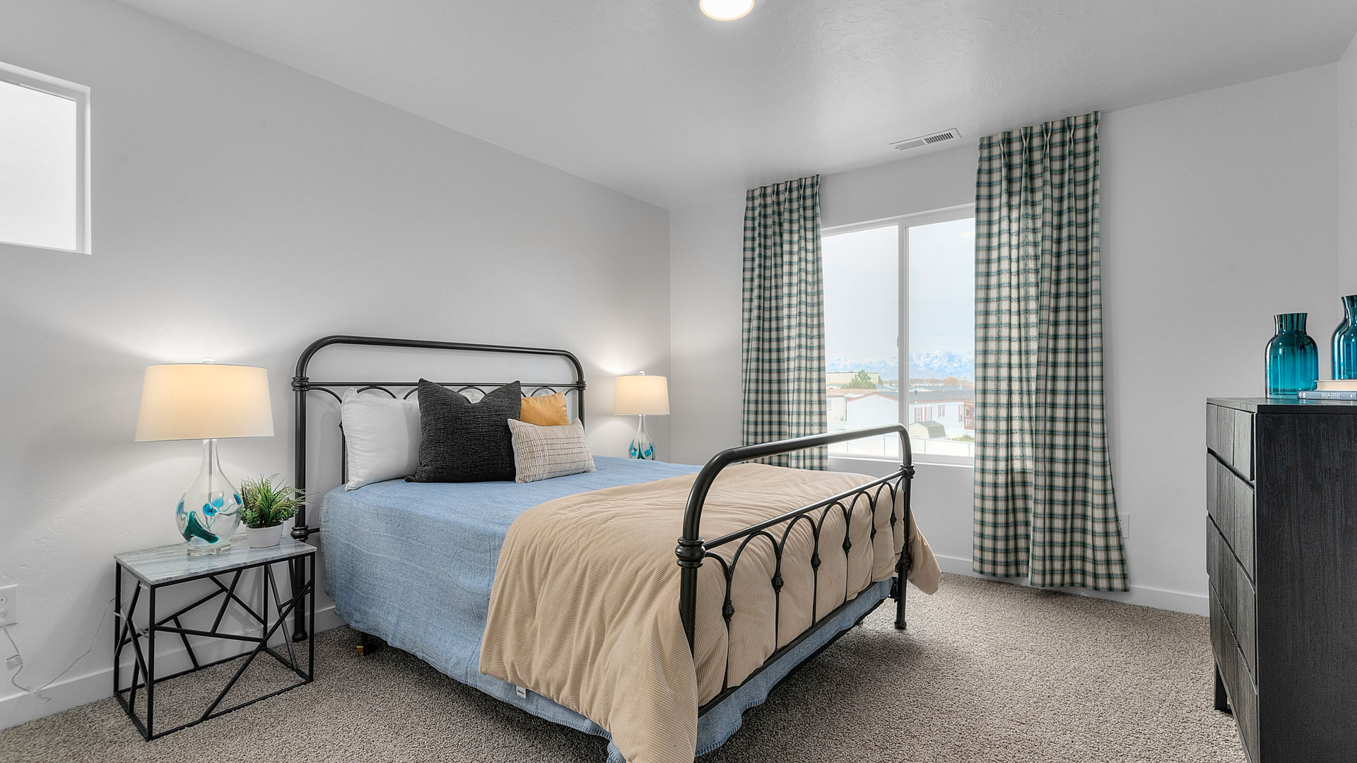 Large secondary bedroom with two windows.