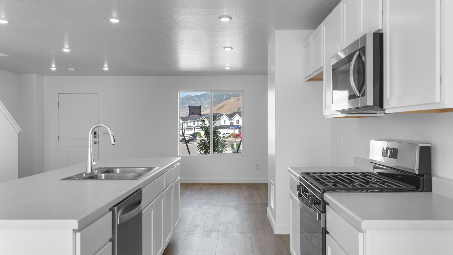 Kitchen featuring large island and stainless steel appliances.