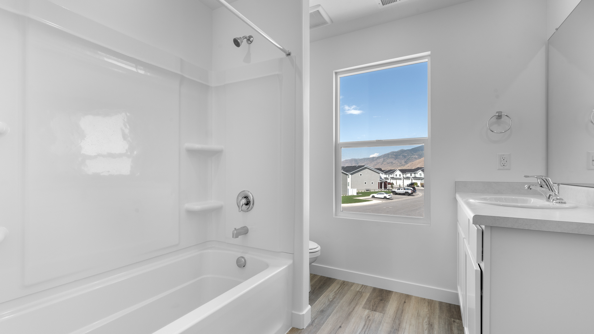 Primary bathroom with window and shower surround.