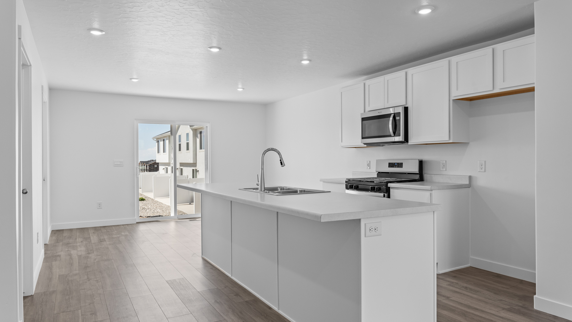 Kitchen with large kitchen island and stainless steel appliances.