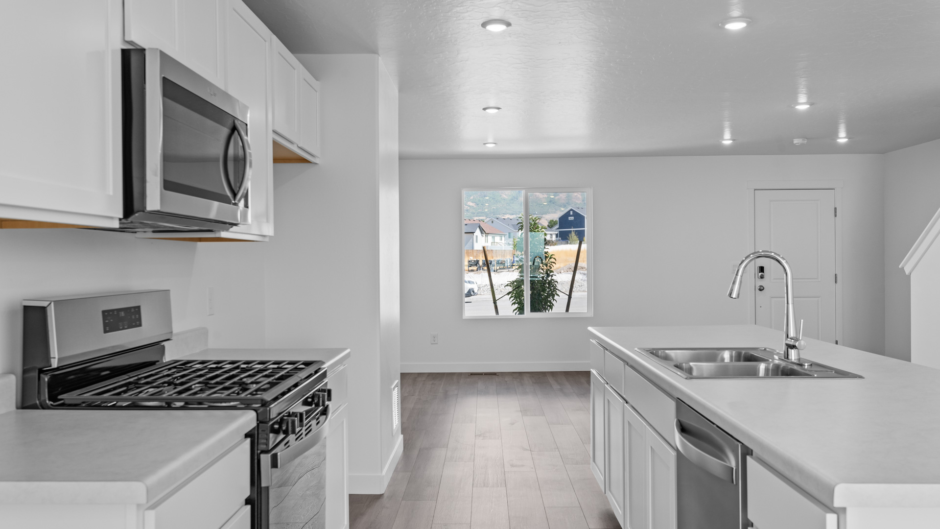 Kitchen with large kitchen island and stainless steel appliances.