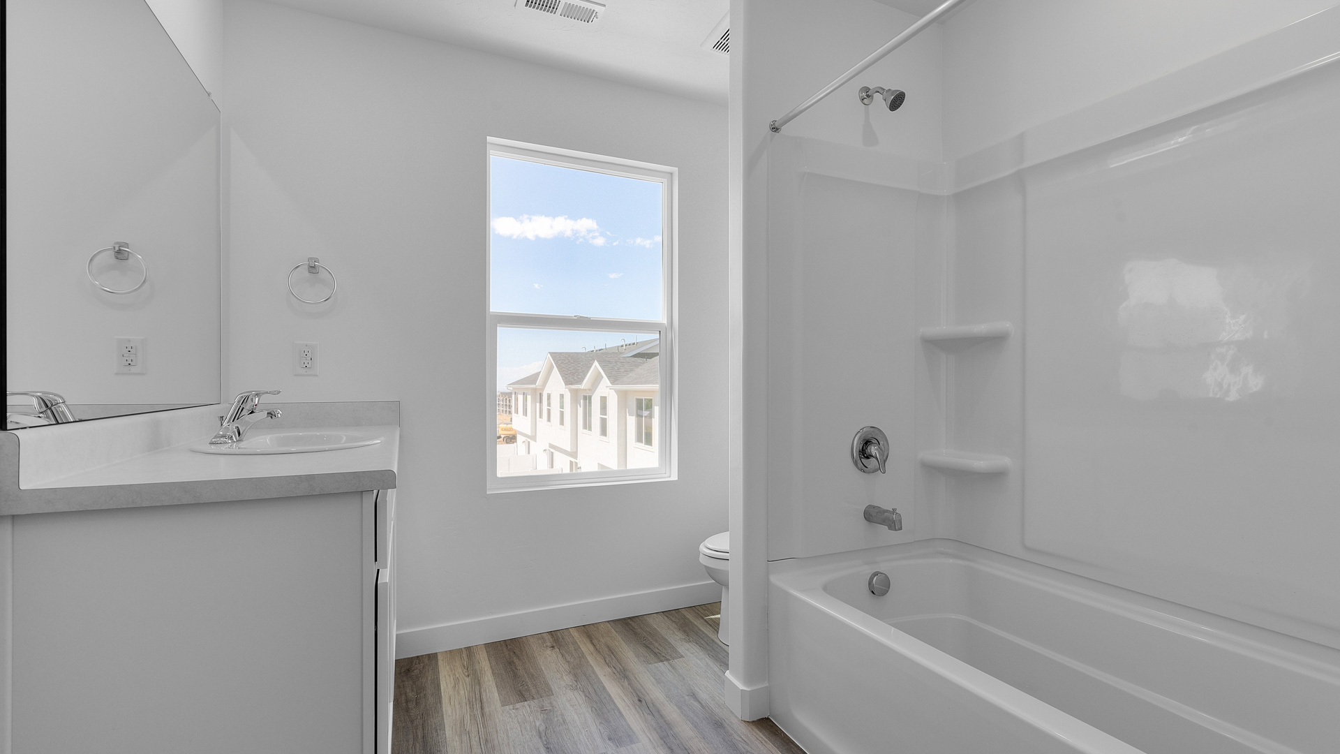 Primary bathroom with window and shower surround.