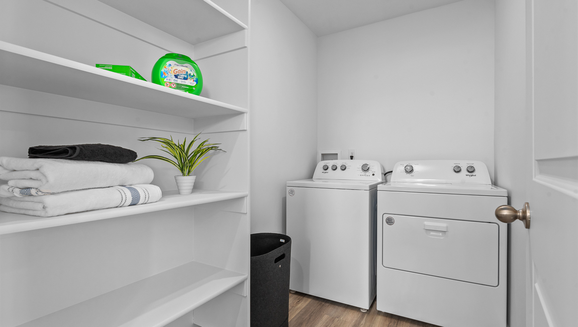 Laundry room with storage shelves.