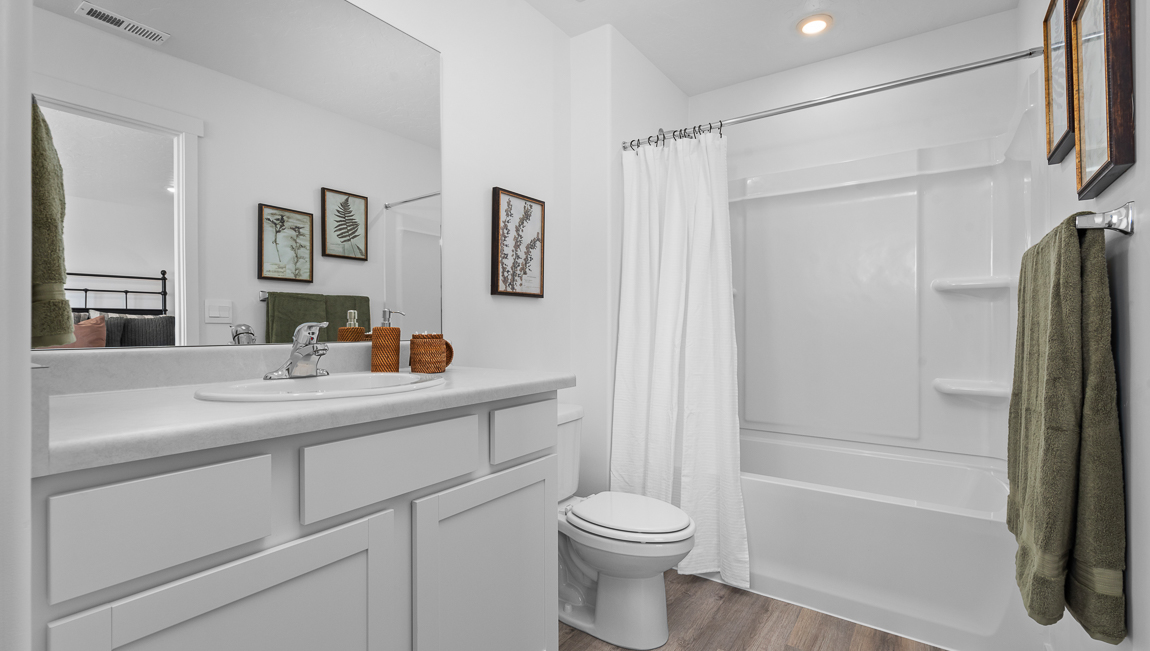 Primary bathroom with shower surround.