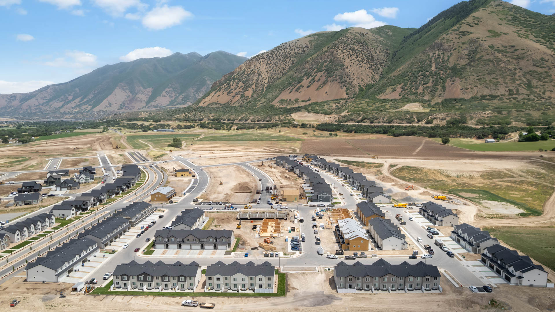 Viridian community aerial showcasing homes being built and mountains.