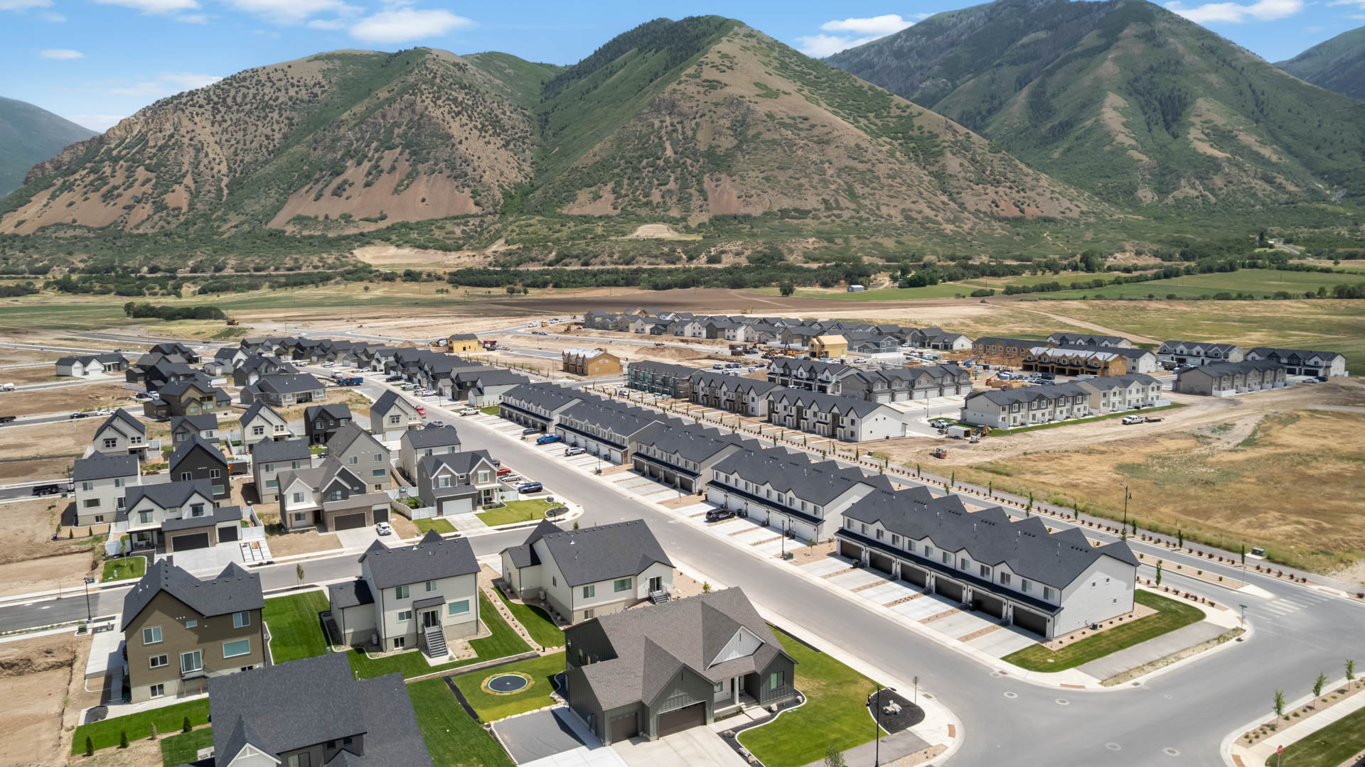 Viridian community aerial showcasing homes being built and mountains.