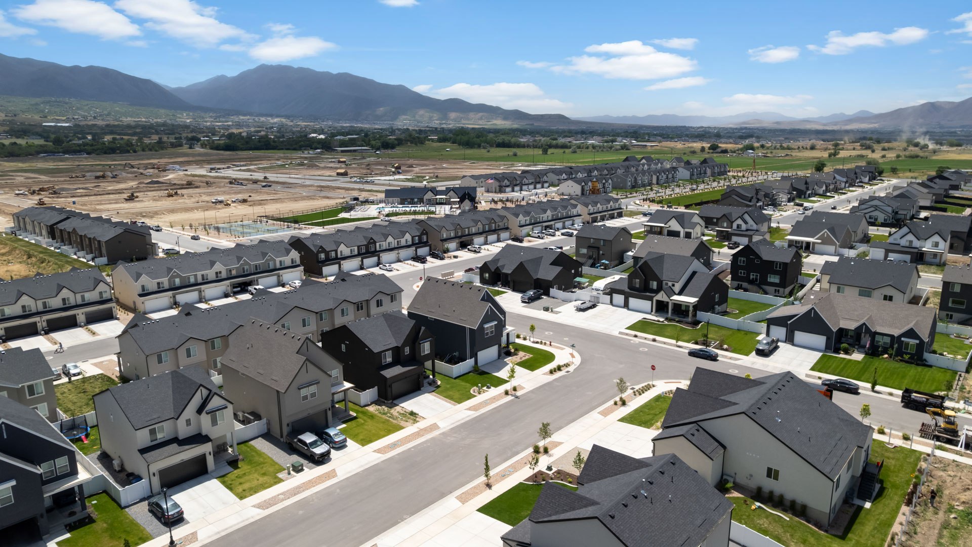 Viridian community aerial showcasing homes being built and mountains.