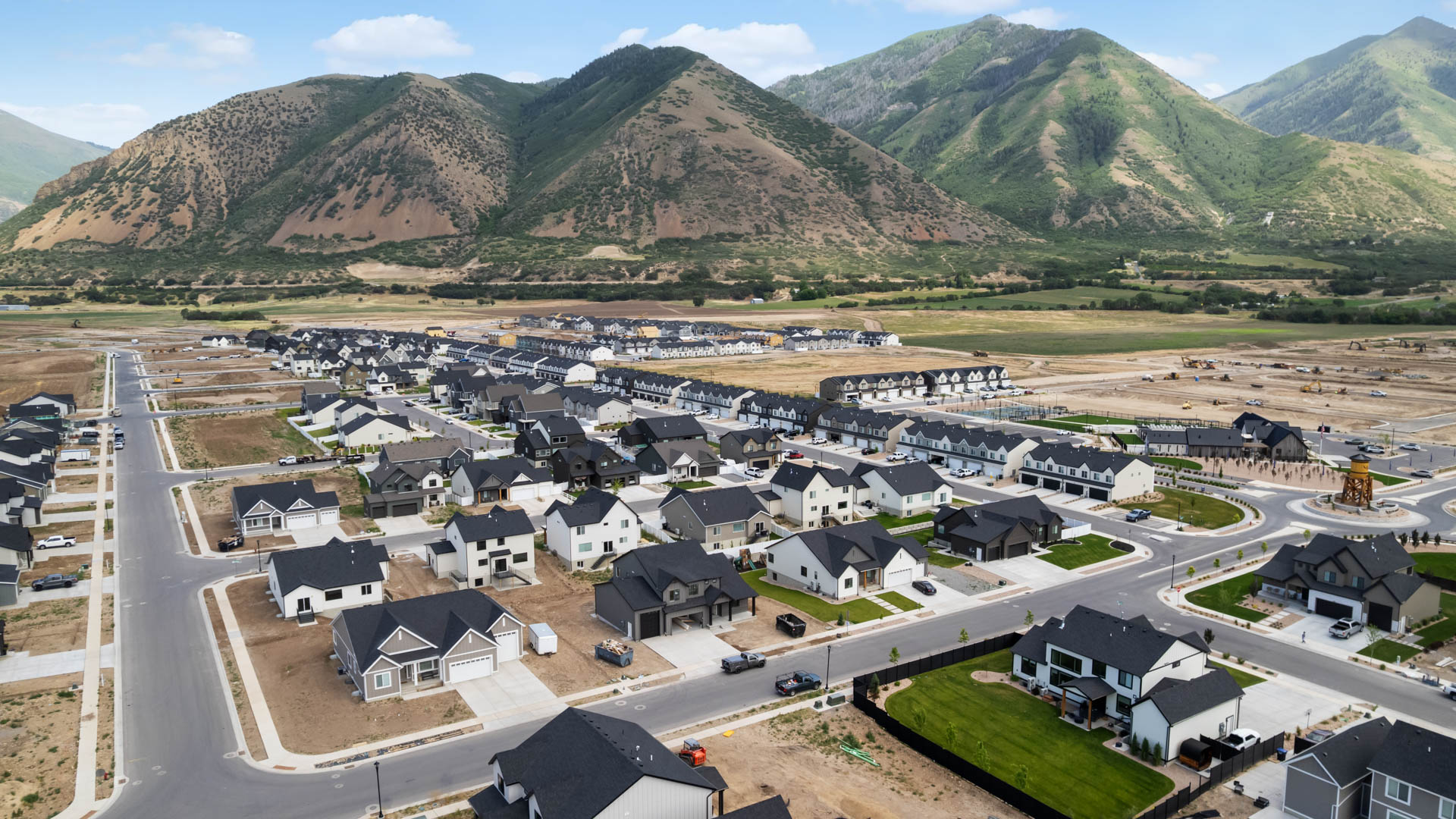 Viridian community aerial showcasing homes being built and mountains.