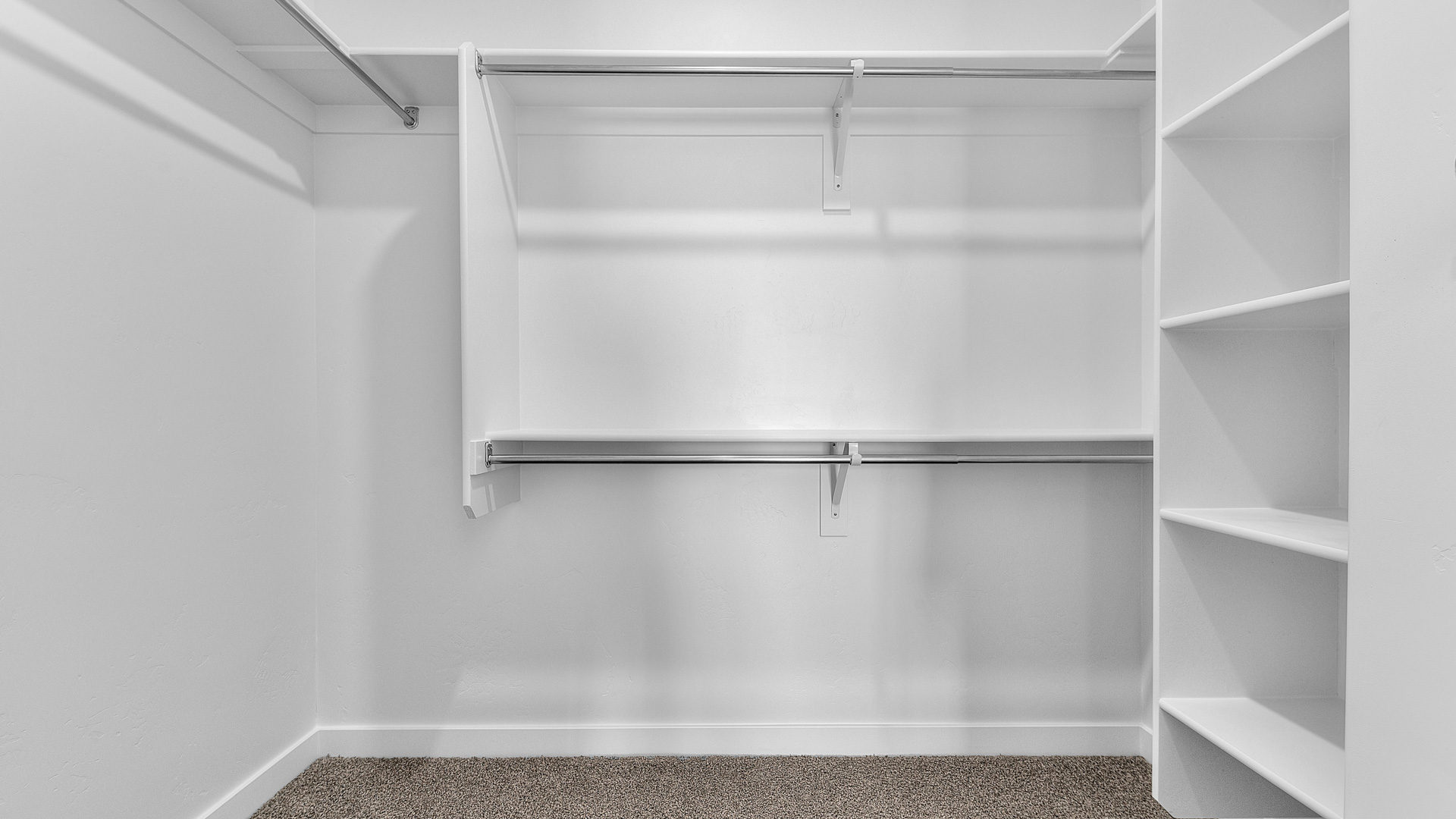 Large primary suite walk in closet with built in organization.