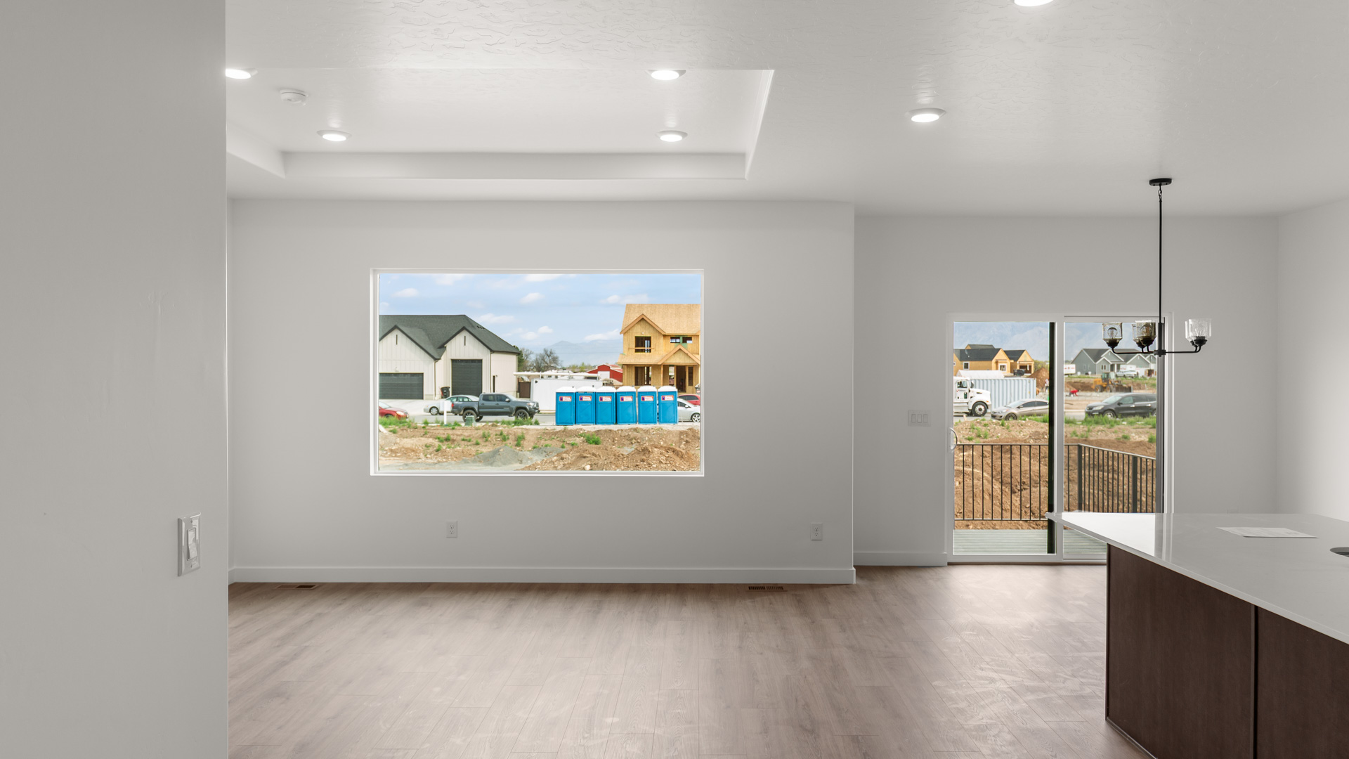 Family room with tray ceiling and large window.