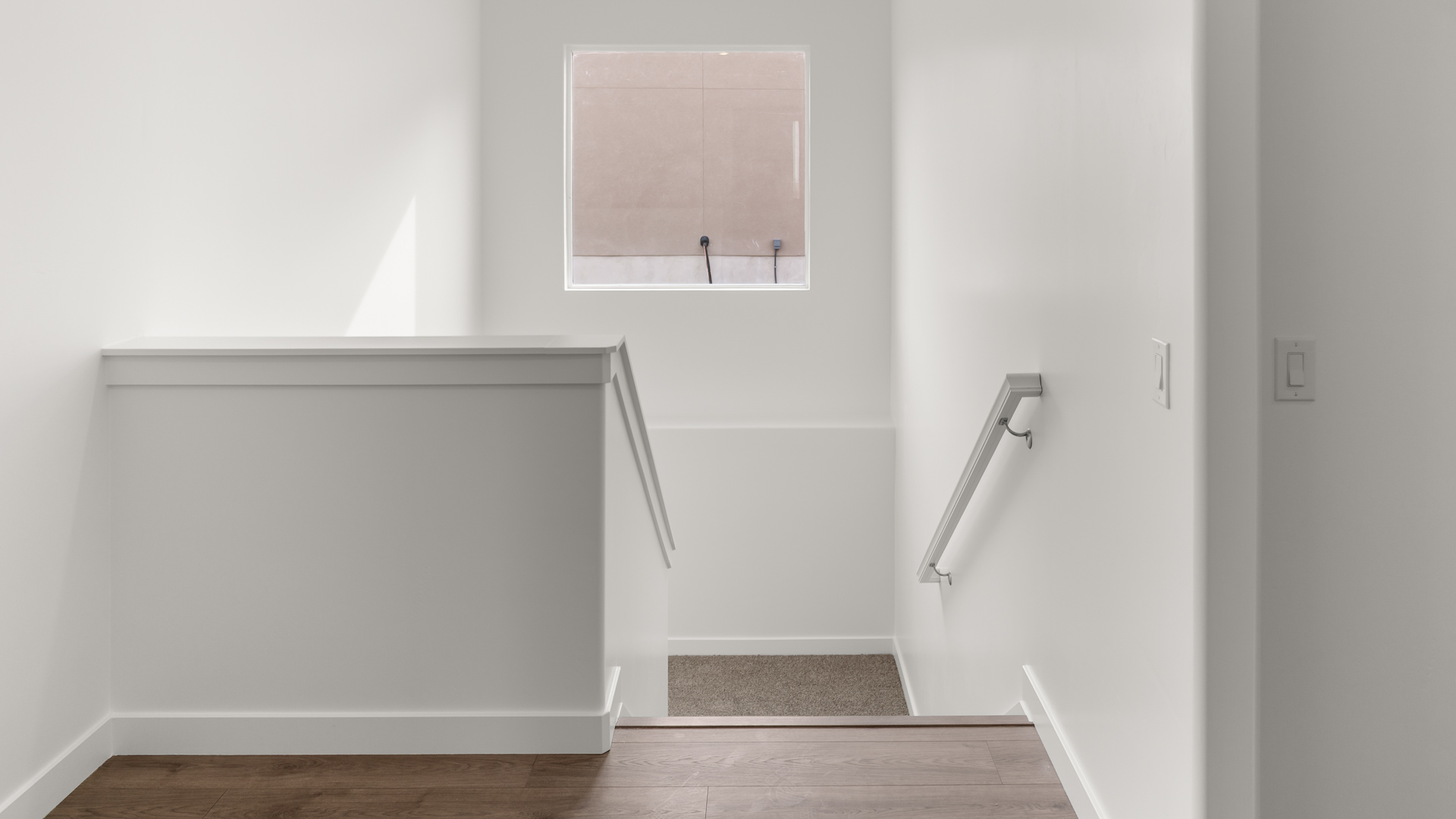 Foyer to stairs with large window.