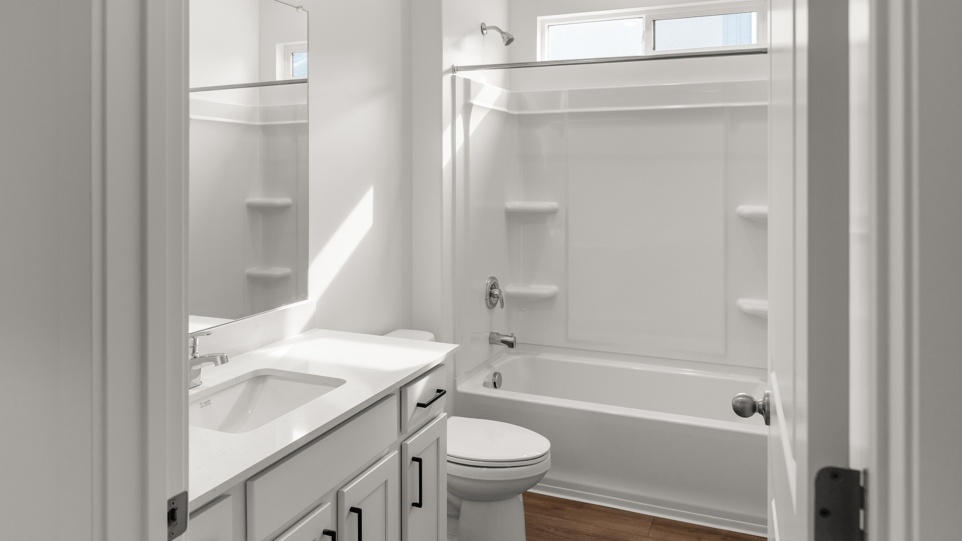 Bathroom with shower surround and window above.