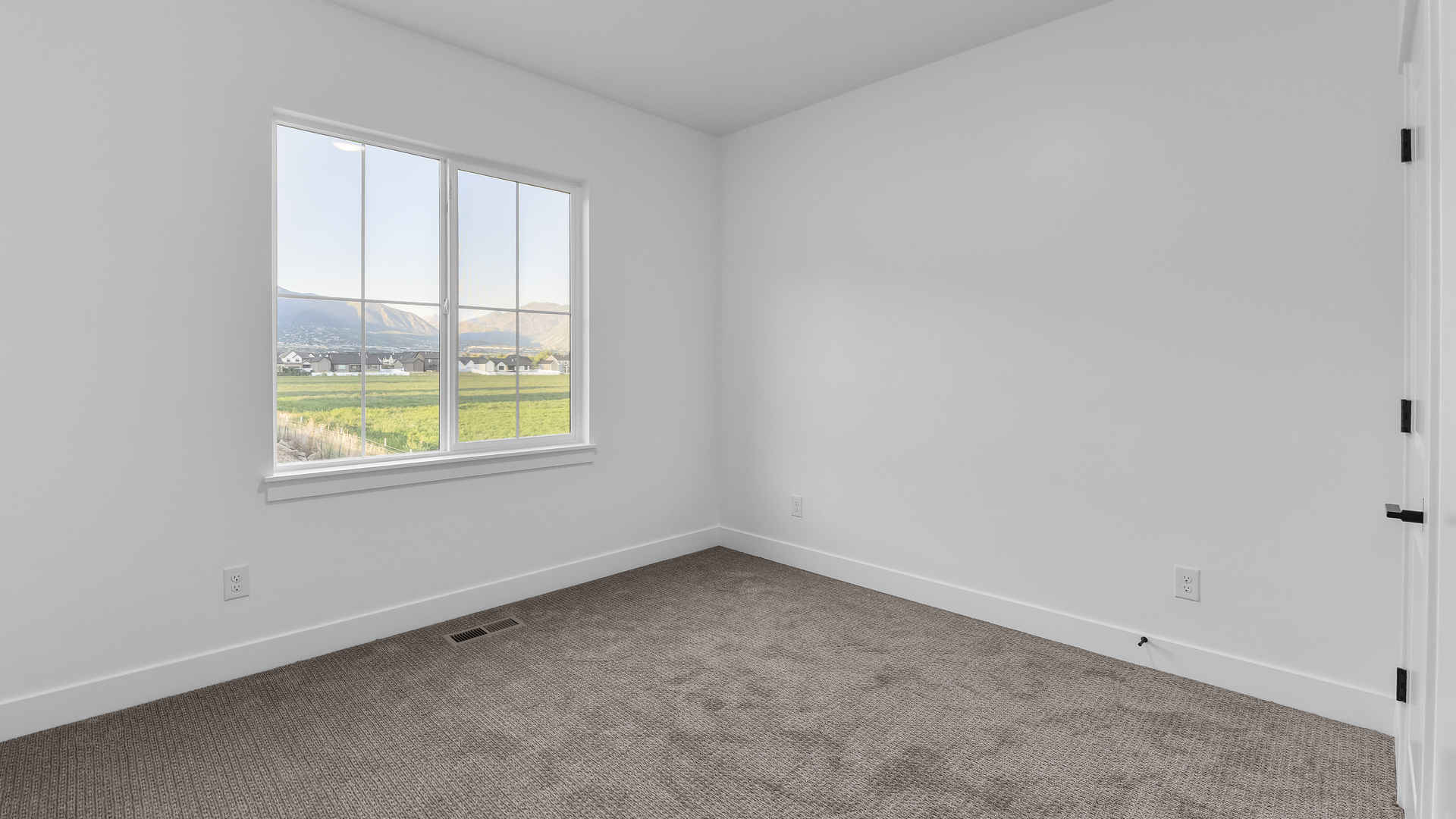 Primary bedroom with large windows