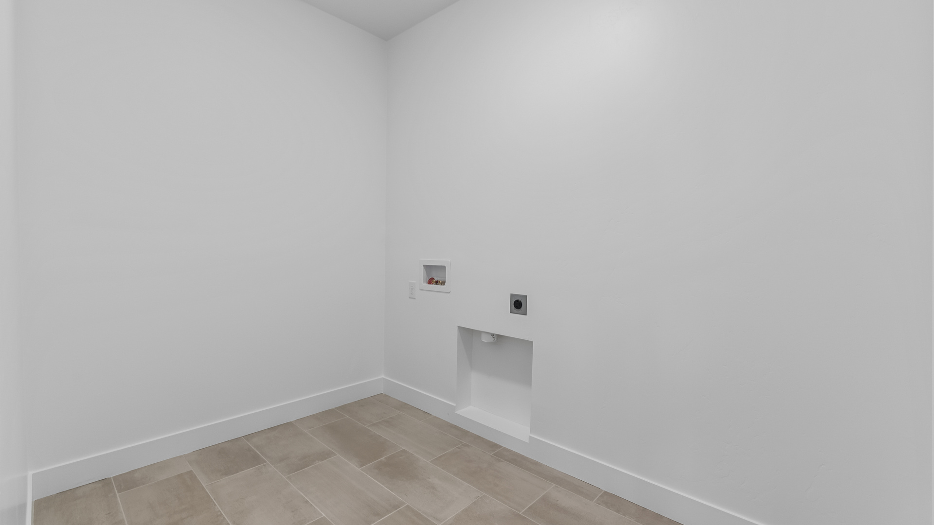 Laundry area behind double doors in hallway